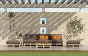 Conjunto de muebles reciclados con palets de madera en una terraza con pérgola, imagen del artículo sobre ideas prácticas para reutilizar palets.